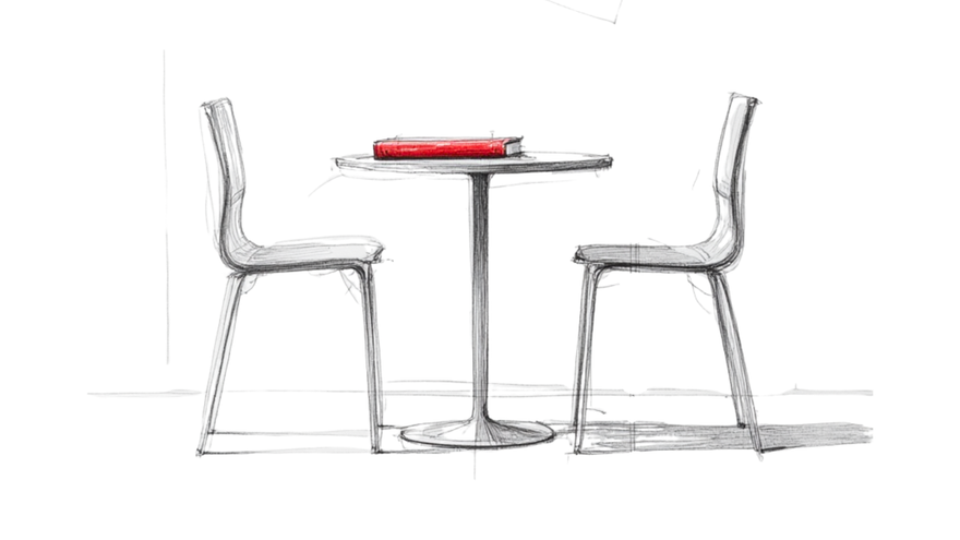 Two chairs facing each other across a small table with a red notebook between them, symbolising quiet conversation and the power of silence.
