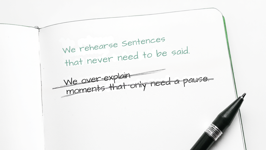 A notebook open with a black pen resting beside it. Two lines of handwriting on the page — one left standing, one crossed out with a single calm line. This is what choosing looks like.